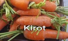 there is a pile of carrots with the words kirot on it in front of them