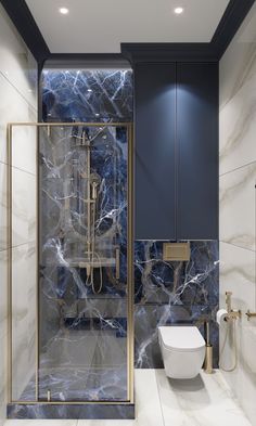 a bathroom with blue marble and gold accents