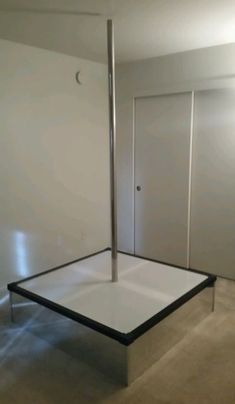 an empty room with two doors and a square table in the middle that has been placed upside down