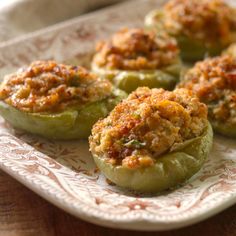 stuffed peppers with meat toppings on a plate