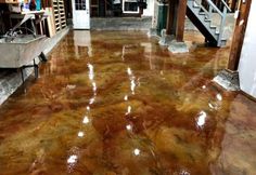 the floor is shiny and brown in this room, with stairs leading up to it