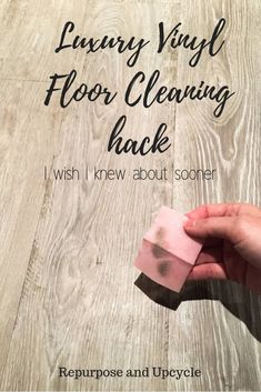 someone is cleaning their floor with a pink sponge and black text that reads, luxury vinyl floor cleaning hack i wish i knew about soon