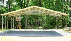 a large metal carport in the middle of a forest