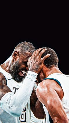 two basketball players with their hands on each other's shoulders, one holding his head