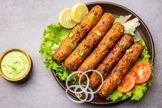 some food is sitting on a plate with lettuce and tomatoes next to it