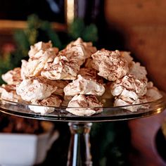 a glass plate filled with marshmallows on top of a table