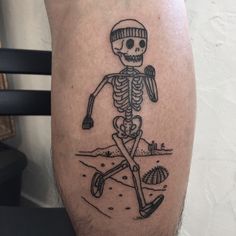 a man with a skeleton tattoo on his leg