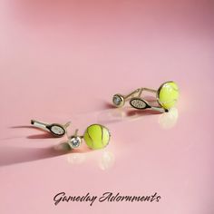 Dainty 6pc 18k Gold Dipped Tennis Earrings Set! Featuring hypoallergenic posts, the set includes tiny tennis racket, enamel tennis ball, and cubic zirconia dainty stud earrings,  each earring is designed to capture the elegance and excitement of the tennis court. Whether you're gearing up for ATP Masters 1000, premier events, or dreaming of Grand Slam glory, these earrings are the perfect accessory for tennis enthusiasts. With their attention to detail and quality craftsmanship, they make a stat Tennis Earrings, Dainty Studs, Tennis Ball, Gold Dipped, Sports Accessories, Sports Fan, Tennis Racket, Earrings Set, Jewelry Earrings Studs