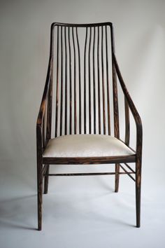 a wooden chair sitting on top of a white floor