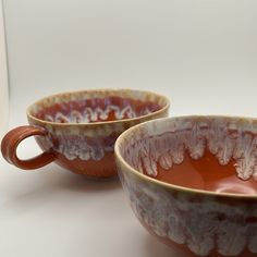 two brown and white bowls sitting next to each other