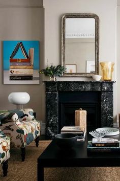 a living room filled with furniture and a fire place in front of a painting on the wall