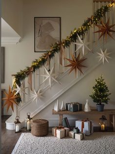 a staircase decorated for christmas with star decorations