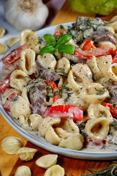 a plate full of pasta with meat and vegetables