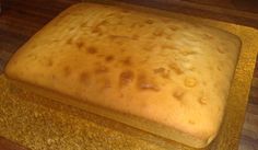 a square cake sitting on top of a wooden counter