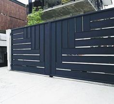 a large black gate in front of a building