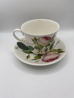 a cup and saucer with flowers on it