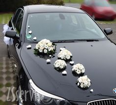 a black car with flowers on the hood