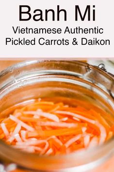 a glass jar filled with sliced carrots and onions