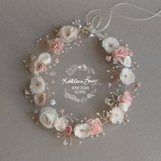 a white and pink flower wreath on a gray background