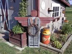 an old shed with some plants growing out of it