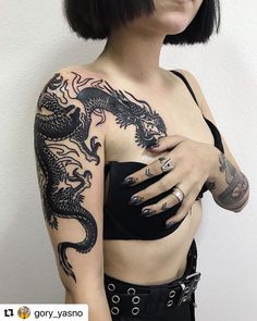 a woman with tattoos on her arm and chest