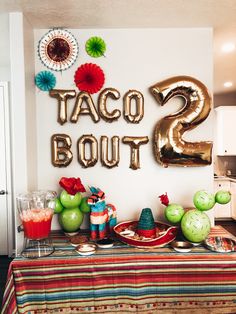 taco bout is displayed on the table with balloons