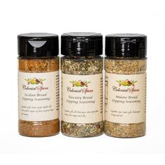 three jars of ground spices sitting next to each other