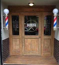 a barber shop front door with the name barberia on it's glass window