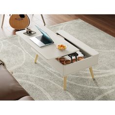 a coffee table with an open drawer underneath it on a carpeted area next to a couch