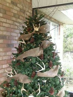 a christmas tree decorated with deer antlers and burlocks