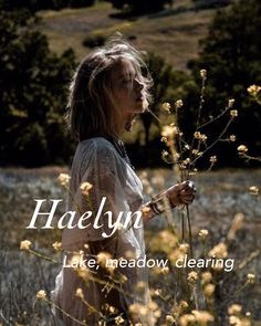 a woman standing in a field holding a plant with the words halelyn on it