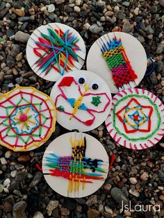 some very pretty decorated rocks on the ground with words written in different colors and shapes