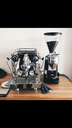 an espresso machine sitting on top of a wooden table