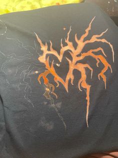 a black shirt with orange designs on it