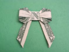 dollar bill origami bow on green background