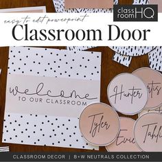 classroom door signs and stickers on a wooden table with black and white polka dots