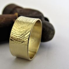 a close up of a gold ring on a white surface