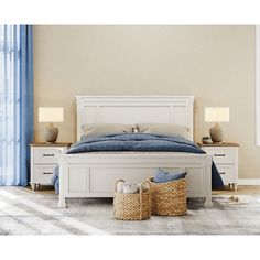 a white bed sitting in a bedroom next to two baskets on top of a table