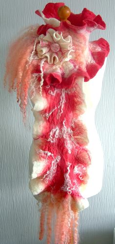 a red and white scarf hanging from a mannequin's head