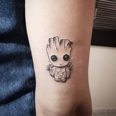 a small baby groote tattoo on the arm