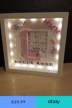 a light up frame with baby's names on it