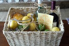 a wicker basket filled with lemons and wine