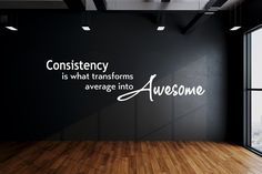 an empty room with a large window and wall decal that says, constistency is what transforms average into awesomeness