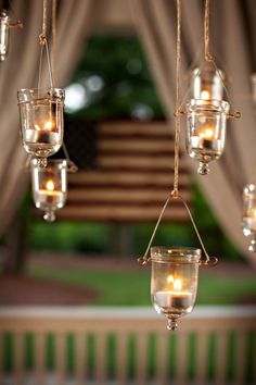 several hanging glass jars filled with candles