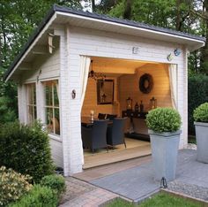 an outdoor living area with potted plants and patio furniture in the back door way