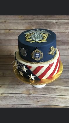 a three tiered cake decorated with an american flag and the crest of the united states