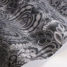 the black and white paisley pattern on this tie is very intricately detailed, yet unbuttoned