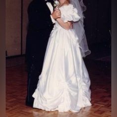 a bride and groom pose for a photo on the dance floor at their wedding reception