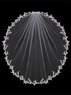 a veil with flowers on it is shown in front of a black background and the top half