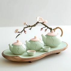 three teapots are sitting on top of a tray